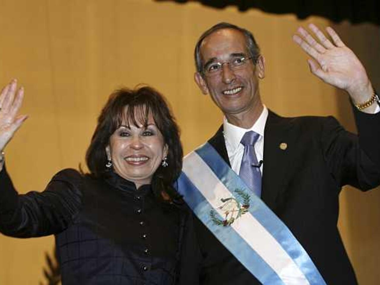 File photo of Guatemala's President Colom and his wife Torres waving after his inauguration in Guatemala City Guatemala's President Alvaro Colom and his wife, first lady Sandra Torres, wave after his inauguration in Guatemala City in this January 14, 2008 file photo. Torres tearily announced on March 24, 2011 she had divorced her husband President Colom for the sake of the nation, thereby hoping to skirt a law in Guatemala that blocks the president's relatives from running for office. REUTERS/Daniel LeClair/Files (GUATEMALA - Tags: POLITICS PROFILE)